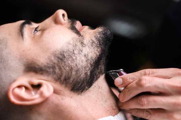 barber shaving client beard